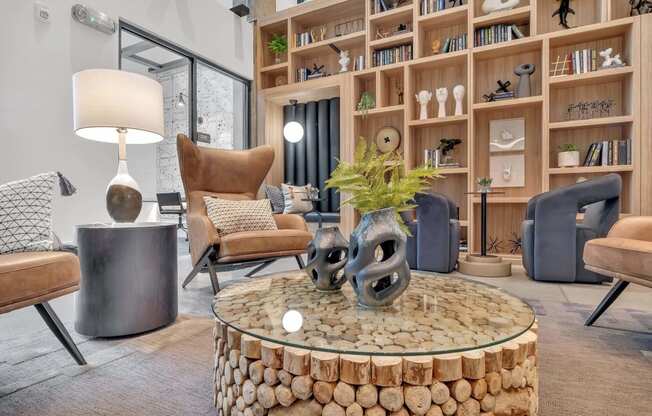 a living room filled with furniture and a large book shelf