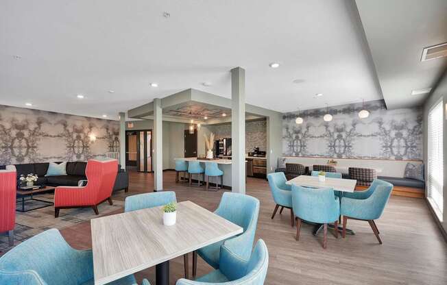 A dining room with blue chairs and a wooden table.