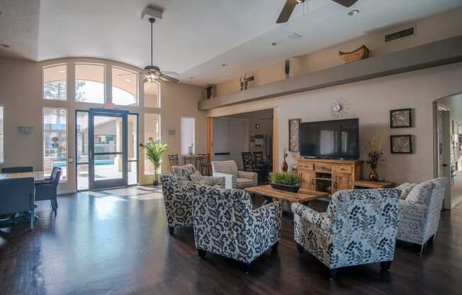 a living room with couches and chairs and a television