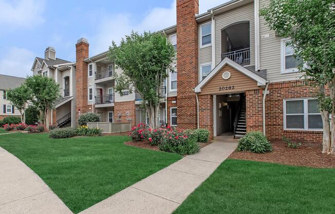 a large lawn in front of a brick building
