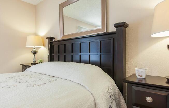 a bedroom with a bed and desk in a hotel room