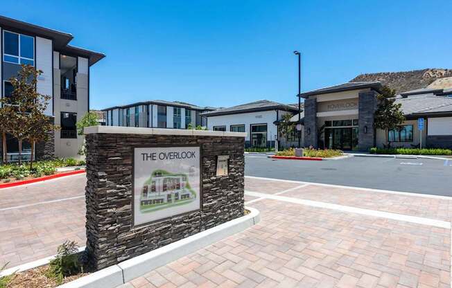 The Overlook building with a sign in front of it.