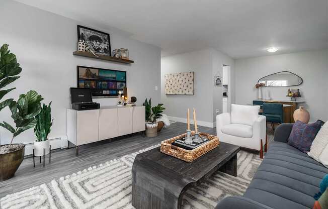 a living room with couches and chairs and a wall with the word rhymerce at The Heights Apartments, Cincinnati, OH