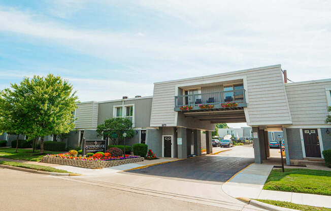 a white building with a balcony and a sidewalk