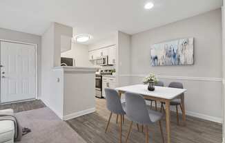 a dining room with a table and chairs and a kitchen