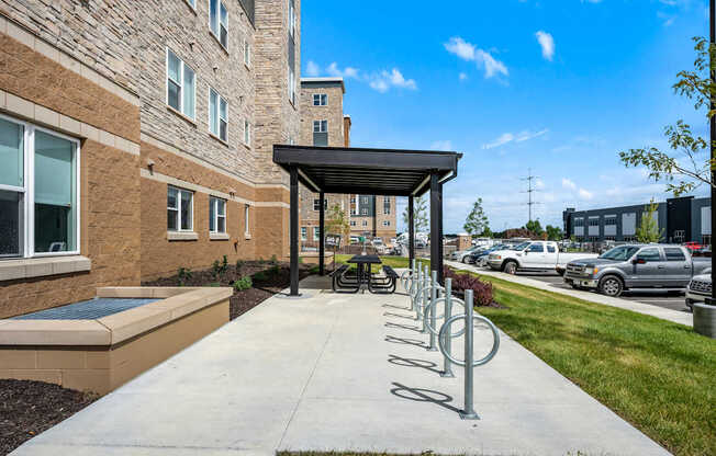A row of bicycle racks are outside a building.