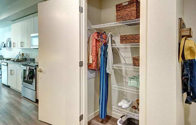 a closet with shelves in a kitchen with a stove and