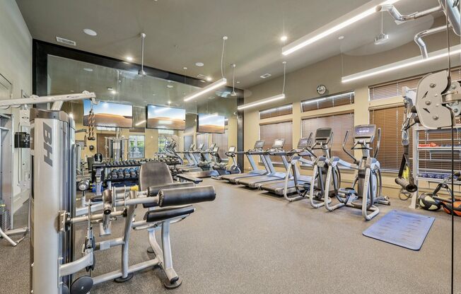 A well-equipped gym with a variety of machines and weightlifting equipment.
