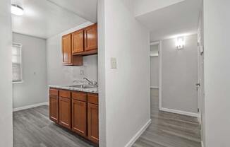 two views of a kitchen and a room with a counter