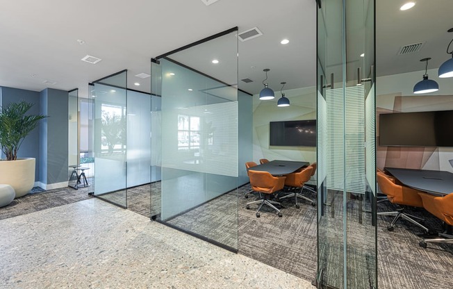 a conference room with glass walls and a table and chairs