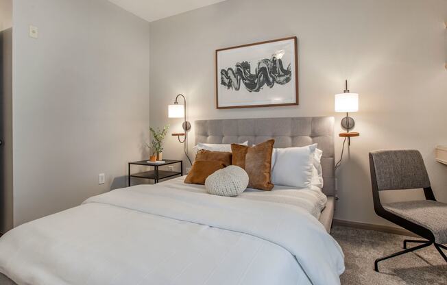 a bedroom with a large white bed and pillows at Reserve by the Lake, Houston, Texas