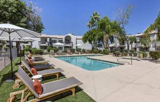 Chic poolside retreat with lounge chairs and umbrellas, right outside our building at Boulders at Lookout Mountain Apartment Homes, Phoenix, 85022
