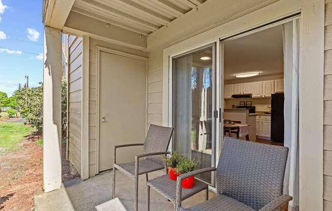 A patio with a chair and table is shown.