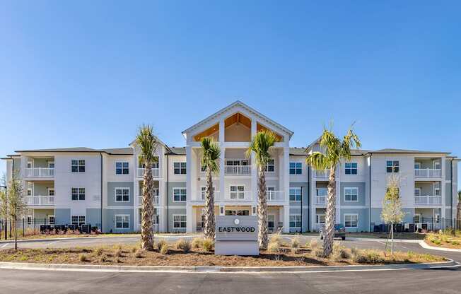 A large apartment complex named Eastwood with a clear blue sky in the background.