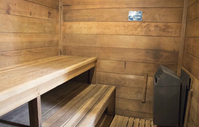 A sauna room with wooden walls and benches.