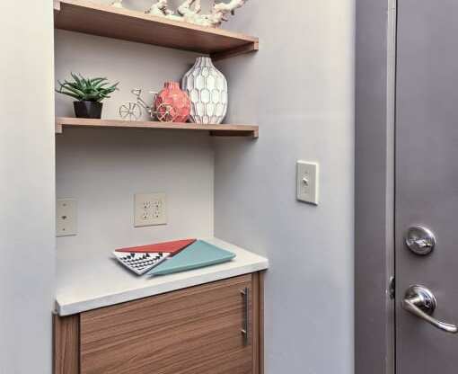 a small bathroom with a cabinet and shelves