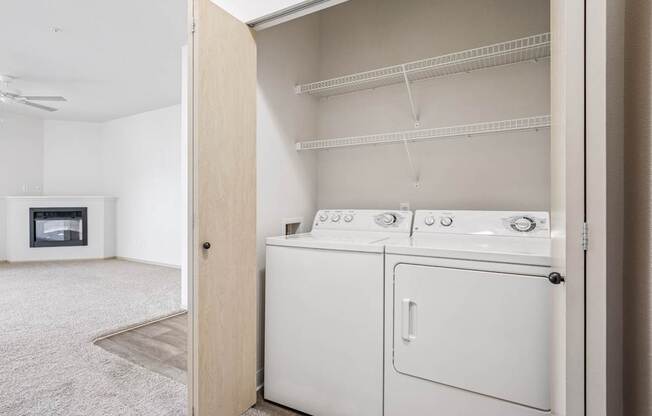 A laundry closet with a full size washer and dryer at The Madison Apartments in Olympia, WA