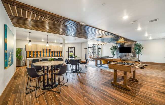 a game room with a pool table and a bar