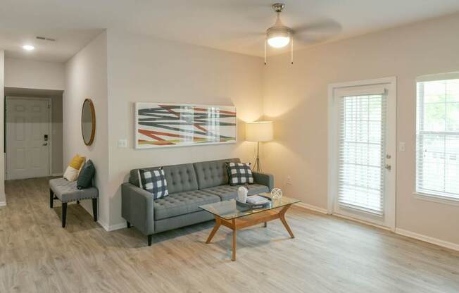 A living room with a grey couch and a coffee table.