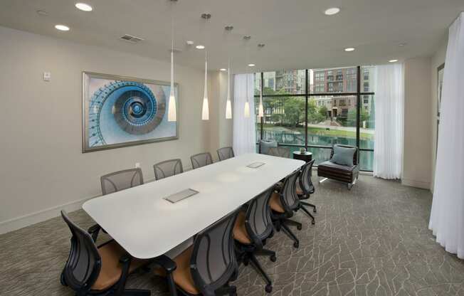 a conference room with a long white table and chairs