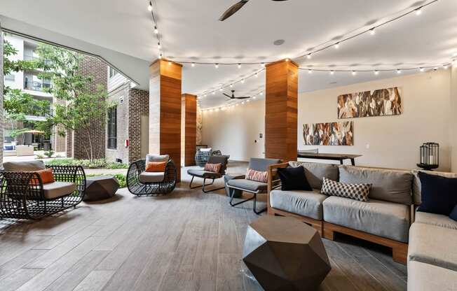 a living room with a couch and chairs and a large window