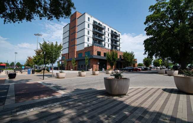 a city street with a building and trees