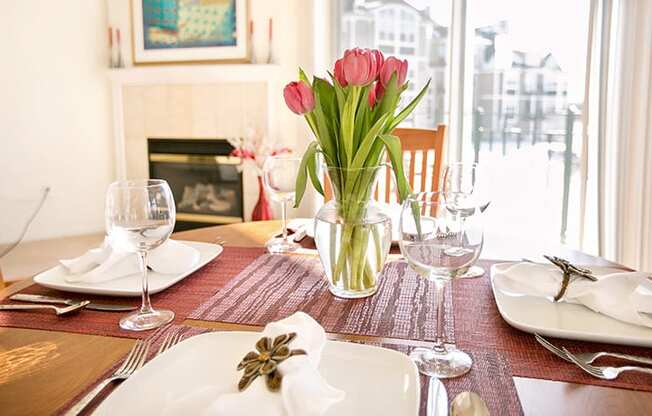 a table with a vase of flowers on top of it