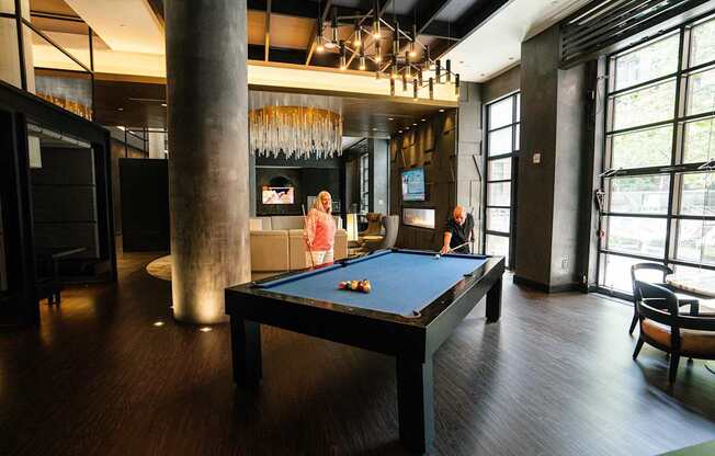 A woman is playing pool in a room with a pool table.
