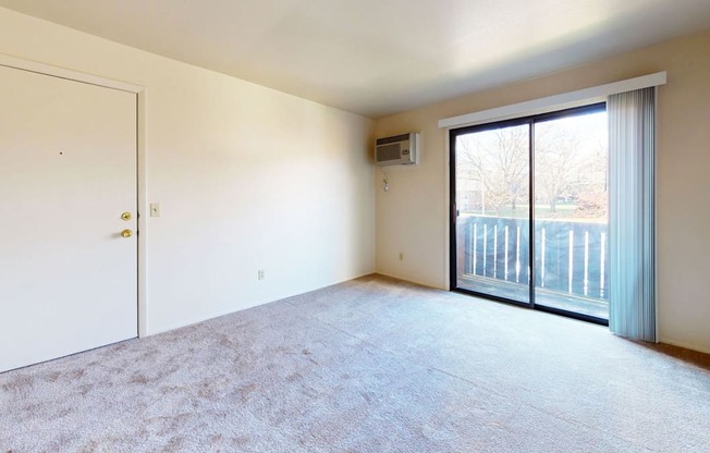 living room with a sliding door to a private balcony