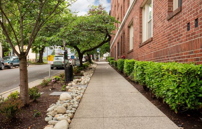 Street View of Property with Manicured Bushed and Rock Lined Tree Area  at Stockbridge Apartment Homes, Washington, 98101