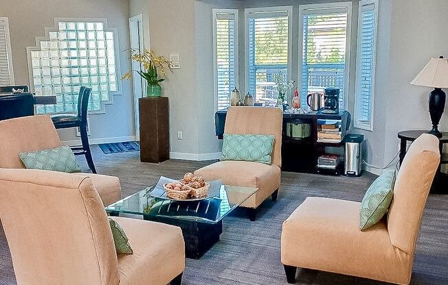 A living room with a glass table and four chairs.