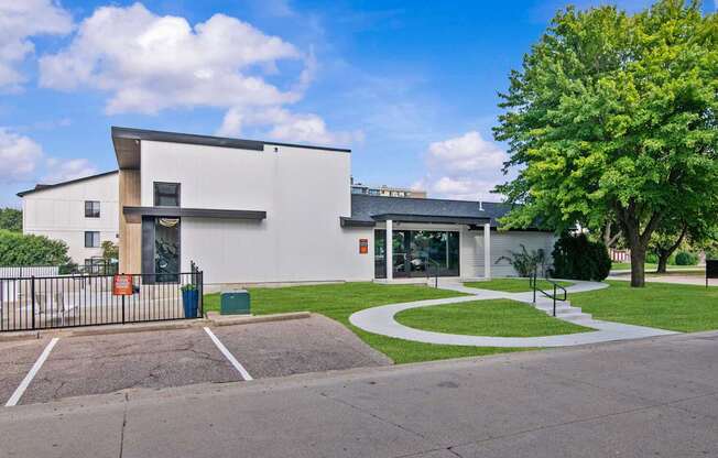 A white building with a black gate in front.