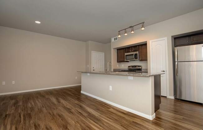 wooden cabinets and appliances in kitchen and dining area1 at The Cantera by Picerne, Las Vegas, 89139