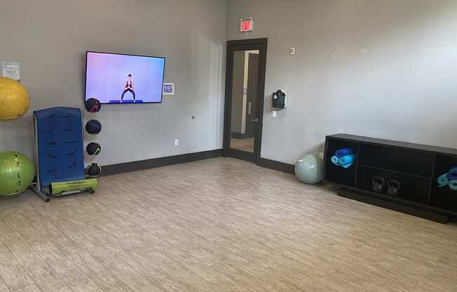 a room with a tv and exercise equipment