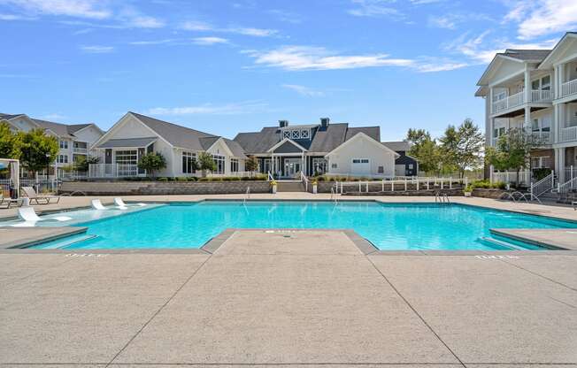 a swimming pool with apartments in the background