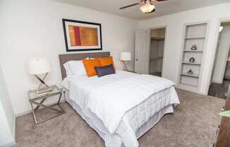 View of bedroom showing built-in shelving and walk-in closet.