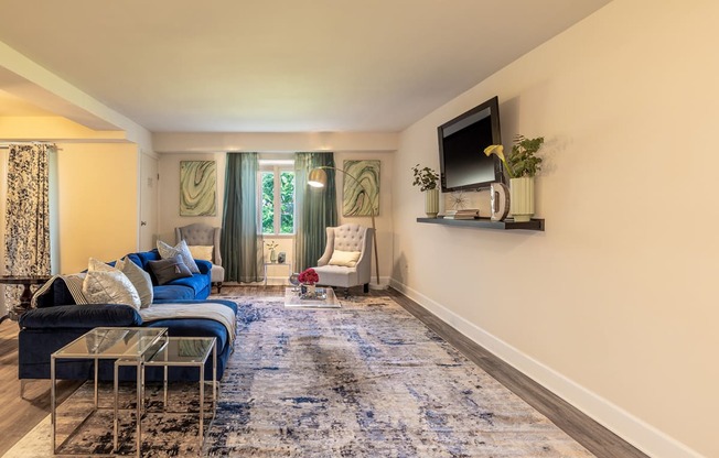 a living room with a blue couch and a television