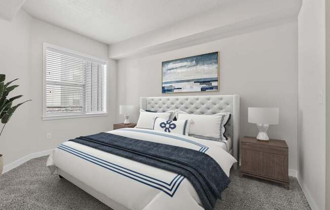 A bedroom with a large bed and a painting on the wall.