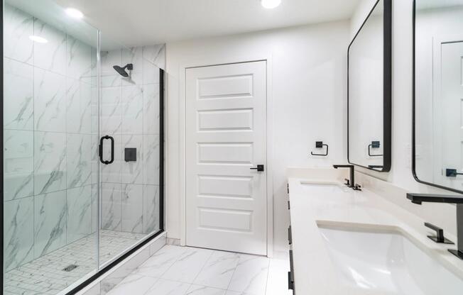 Spa-inspired bathrooms feature double vanities, frameless glass showers, marble-inspired tile surrounds, and contemporary fixtures that elevate everyday routines.