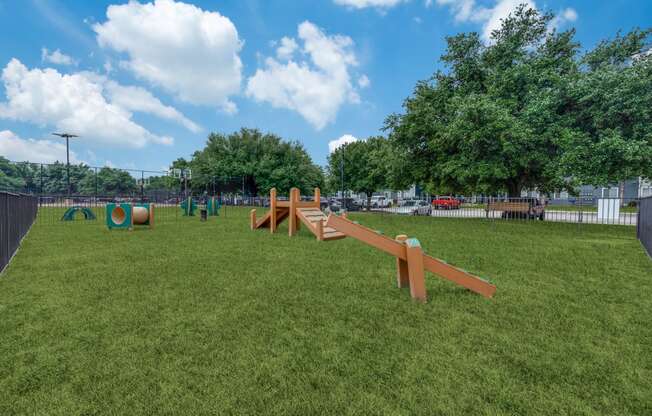 a park with a seesaw in the middle of the grass