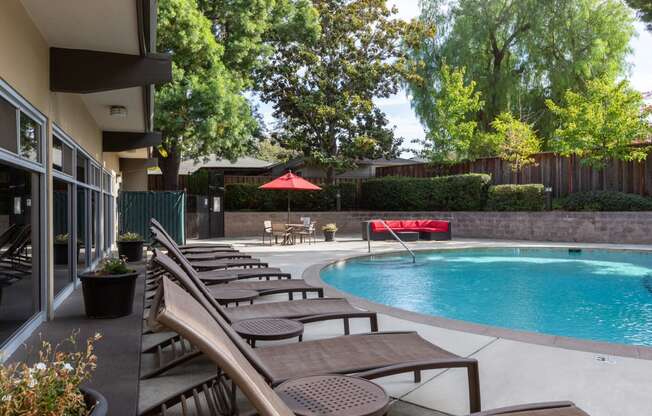 Outdoor pool area with lounge chairs