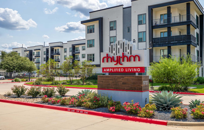 Rhythm Exterior Sign with landscaping and oversized balcony