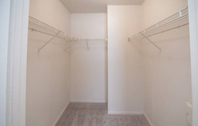 an empty closet in a room with white walls