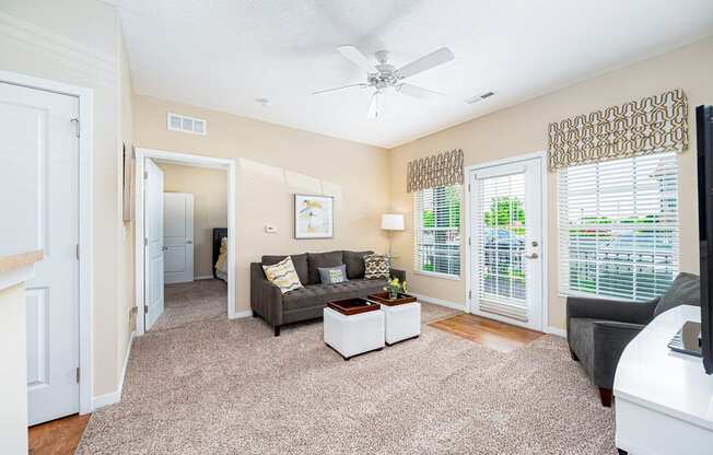 a living room with a couch and a ceiling fan