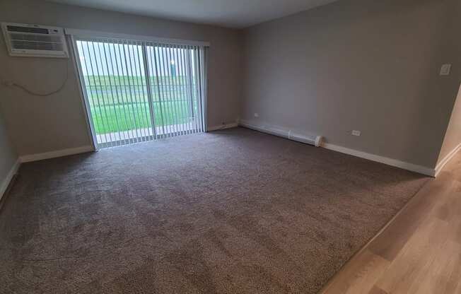 an empty living room with a sliding glass door