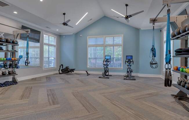 A spacious room with exercise equipment and a large window.
