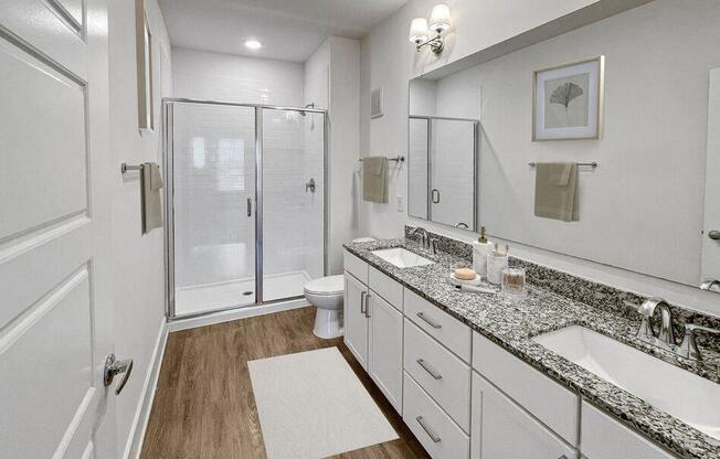 a bathroom with two sinks and a shower at The Merchant Apartments, Charleston, South Carolina