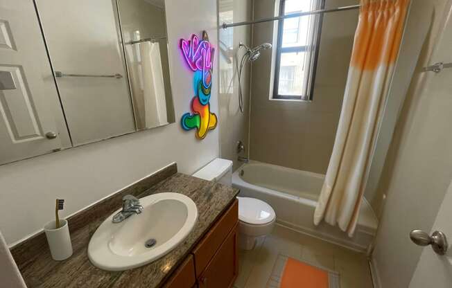 a bathroom with a sink and a toilet and a shower