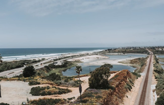 a view of the beach and the freeway next to the ocean