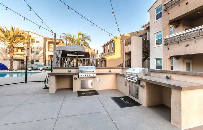 A patio with a grill and a table is set up on a rooftop.